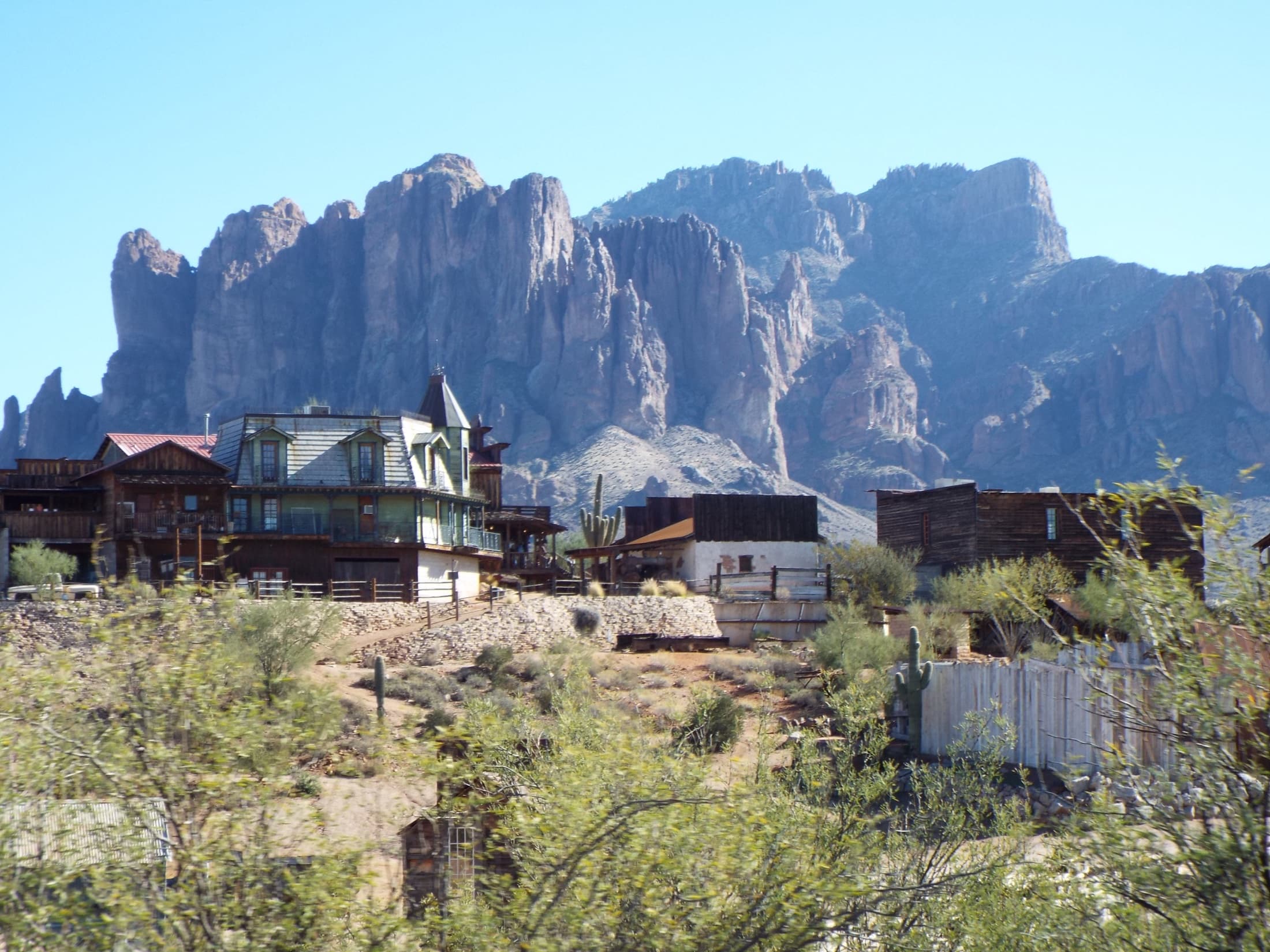 Goldfield Ghost Town with the Superstition Mountains rising behind it