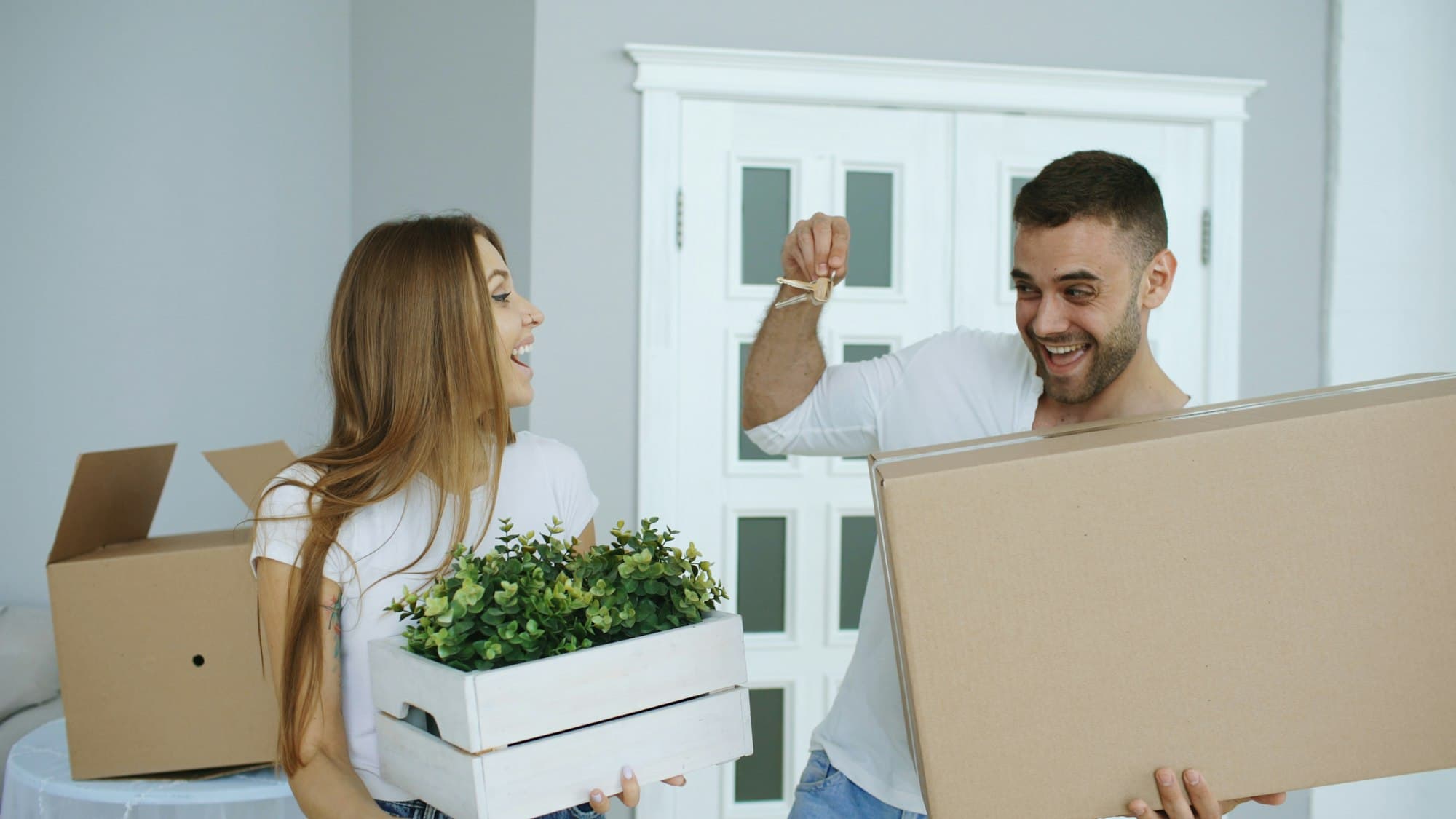 Happy young couple celebrating with new house keys