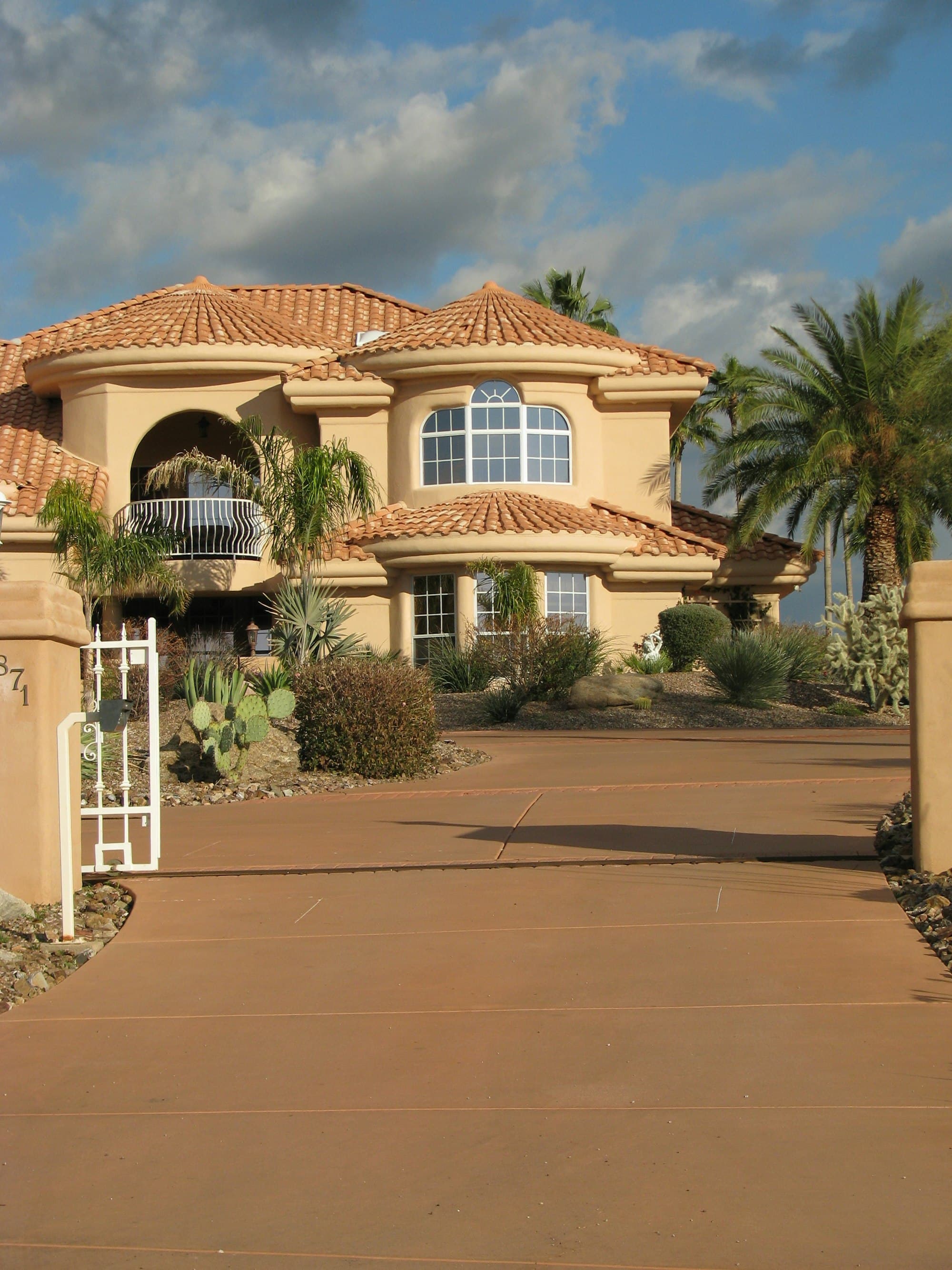 A desert home with a spacious driveway and xeriscaped front yard in Gold Canyon, Arizona